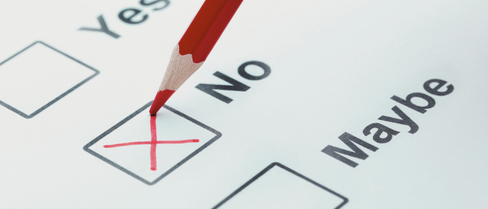 Red pencil marking a cross in the 'No' checkbox on a paper form with Yes, No, and Maybe options, representing discontinued assessments that did not meet evidence standards