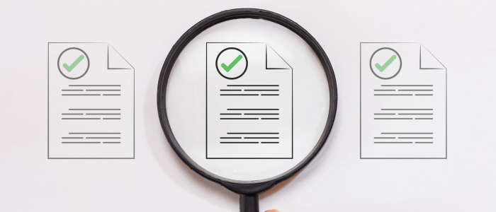 A magnifying glass focussing on a document, symbolizing the second and third Joint Clinical Assessments and comparative evidence across Member State PICOs.