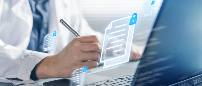 Clinician writes beside a laptop with floating digital medical records and padlock icons indicating secure health data.