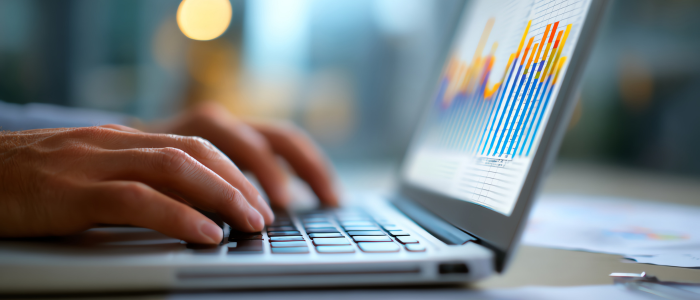 Person typing on a laptop, representing Duke-Margolis’s dashboard tracking the use of registries in FDA decision-making