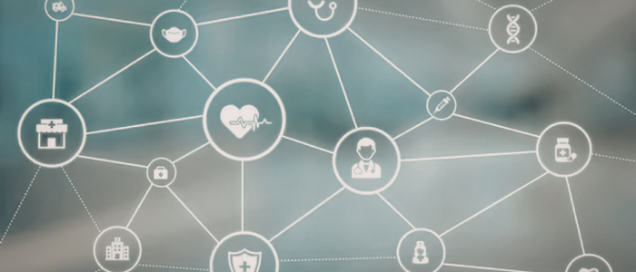 Healthcare icons connected by network lines, including heart, doctor, DNA, hospital, and medicine symbols on a blurred background.