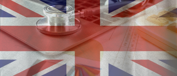 Union Jack flag overlaying a stethoscope and medical documents on a desk, symbolizing healthcare data in the United Kingdom