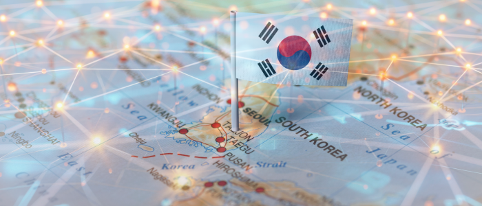 South Korean flag pinned on a map with digital network lines overlaying the image.