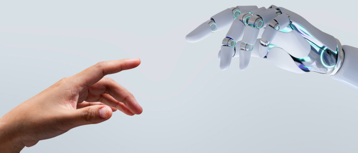Human hand reaches toward robotic hand.