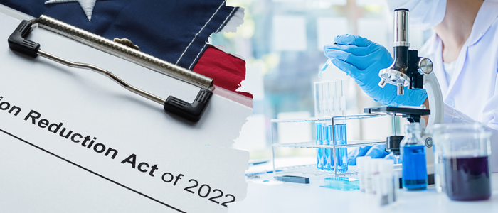 Report on Inflation Reduction Act of 2022 sits beside scientist working with test tubes and microscope.