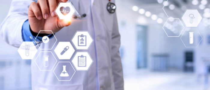 Healthcare professional in a white coat holding a card, representing King’s College Hospital joining the Briya health data network for real-world evidence research.