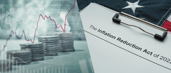 Image depicting a stack of coins with a rising stock chart overlay, symbolizing financial trends, alongside a document titled 'The Inflation Reduction Act of 2022' clipped to a clipboard with a partial view of an American flag in the background
