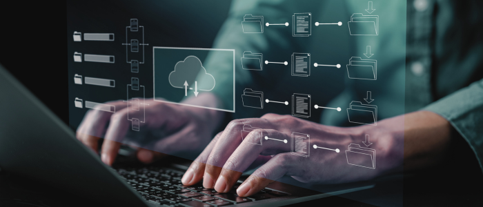 Person types on laptop with digital overlay of cloud storage and data flow icons.