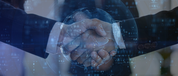Business professionals shaking hands with a digital globe and data overlay, illustrating global healthcare partnership and collaboration.