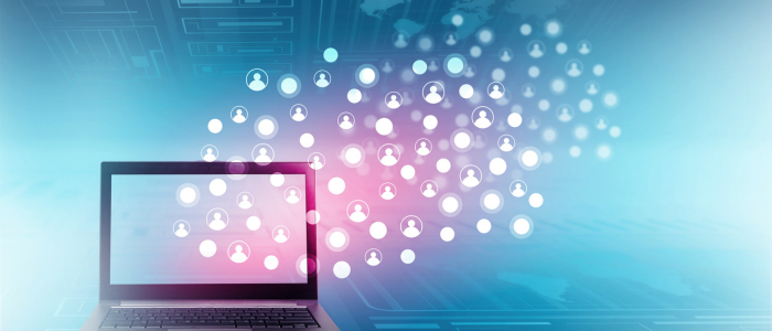 Laptop displaying a digital network of connected user icons against a blue background.