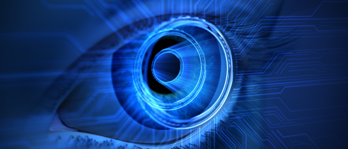 Close-up of a human eye with a glowing blue digital iris and circuit patterns, illustrating AI in ophthalmology.