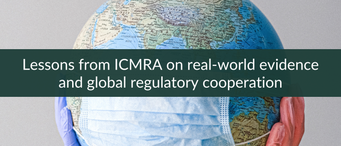 A globe wearing a blue surgical mask, held by hands in medical gloves, with a text overlay saying 'Lessons from ICMRA on real-world evidence and global regulatory cooperation'