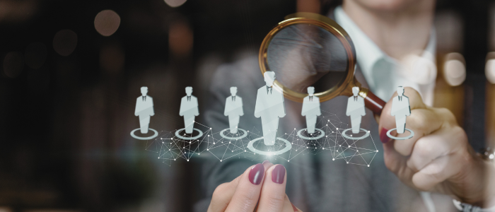 Illustration of AI-assisted patient identification, showing a magnifying glass highlighting one figure from a group of digital patient icons connected by a data network, representing the use of real-world data to identify eligible participants for clinical trials.