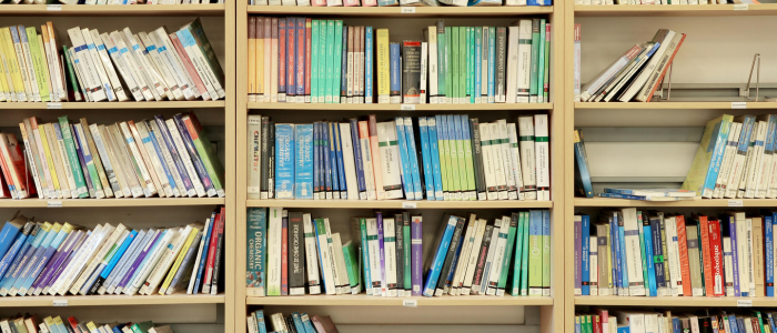 Library shelves filled with books, representing the MHRA’s RWE hub for navigating regulatory guidance
