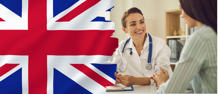 On the left, a UK flag. On the right, a smiling female doctor with a stethoscope around her neck sits at a desk, attentively listening to a female patient. 