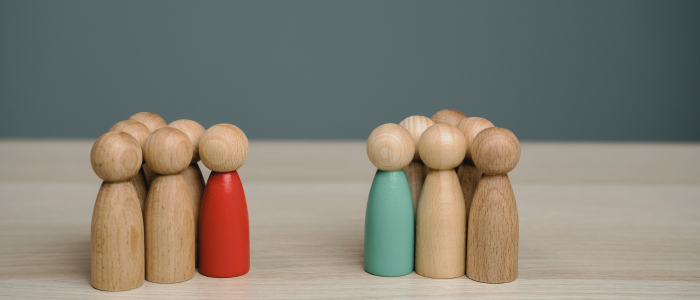 Two groups of wooden figures symbolizing cost-effectiveness comparisons beyond drug launch prices
