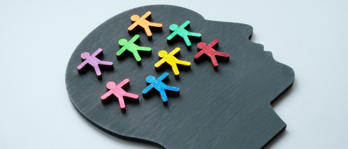 Colorful human figures sit inside head silhouette.