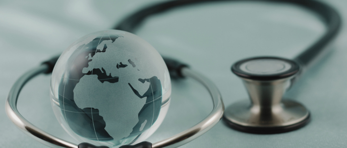 Glass globe rests inside stethoscope, to represent that a new IQVIA report highlights barriers to CAR T-cell therapy access across Europe, Canada and Australia.